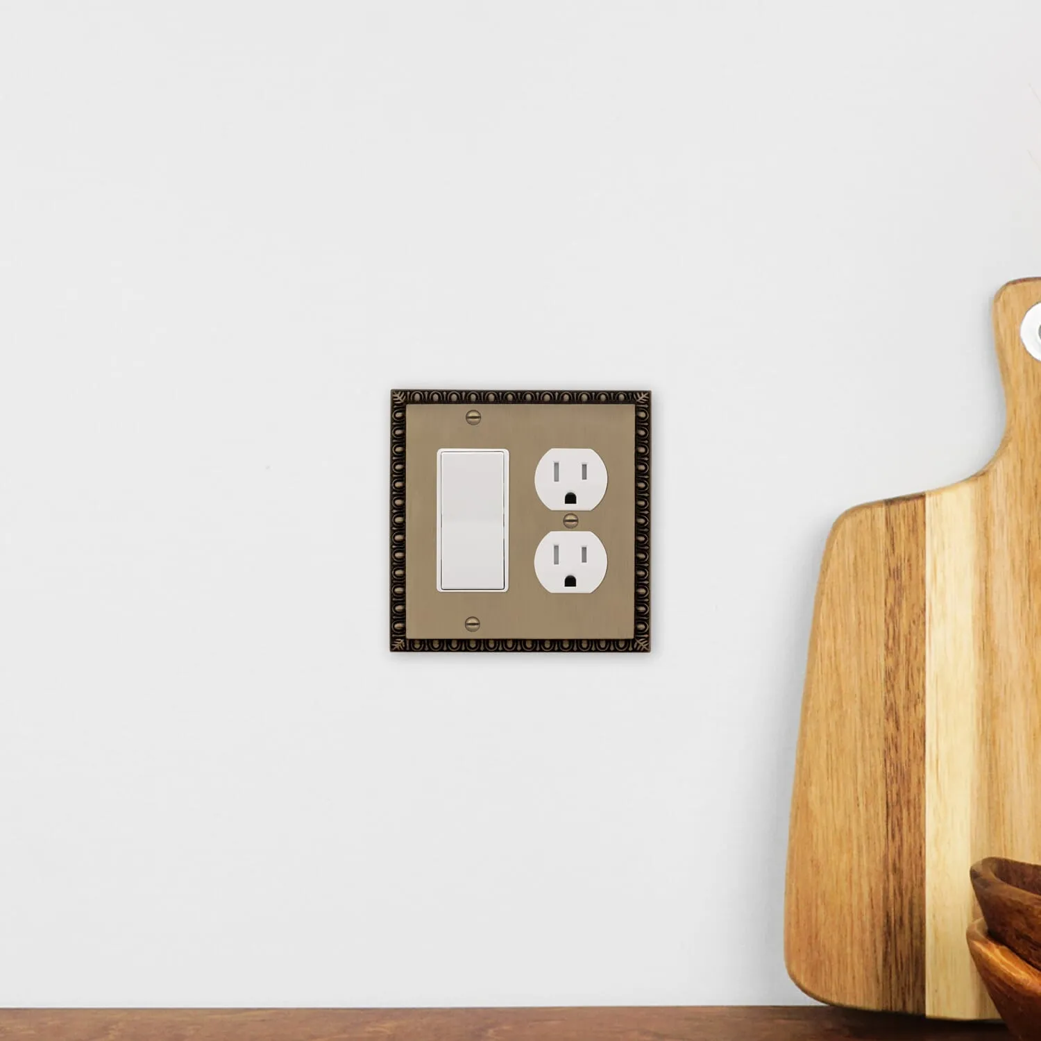 Egg & Dart Switch Plate with Rocker and Outlet in Antique Brass