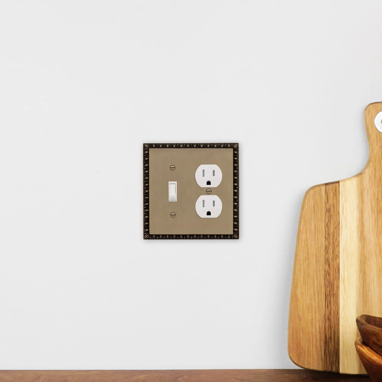 Egg & Dart Switch Plate with Toggle and Outlet in Antique Brass