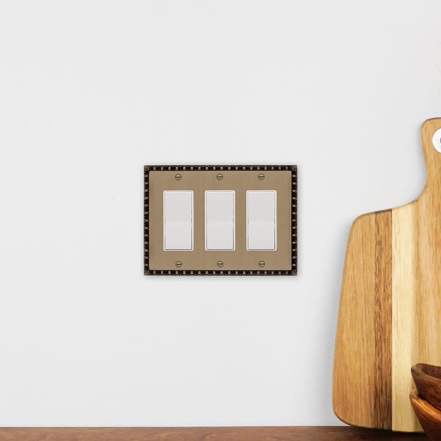 Egg & Dart Switch Plate with Triple Rocker in Antique Brass
